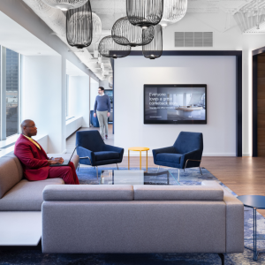 People inside office space with chairs and couches
