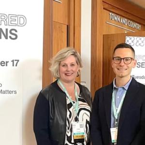 Three people stood in front of "Sponsored sessions" event banner