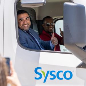 people sitting in a Sysco truck