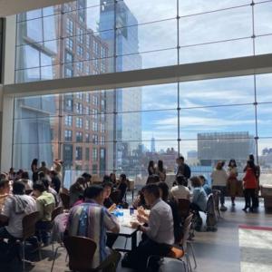 people seated in a large open room at small tables