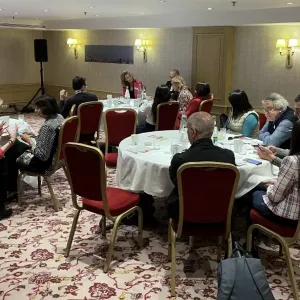 People sitting at tables at workshop