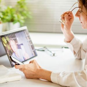 person looking at a tablet and a smart phone