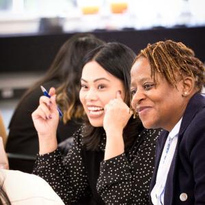 People talking in a business-casual setting.