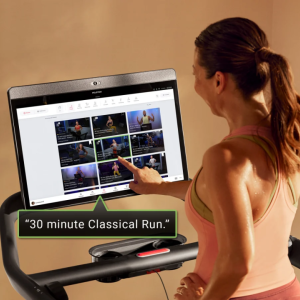 Woman using touch screen with text '"30 minute Classical Run"'