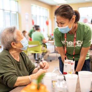 People at a table in masks