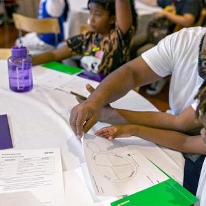 teacher working with a student