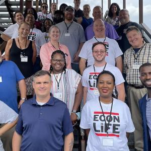 Group of about 20 people on steps up a staircase