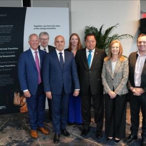A team of people posed in an open room.