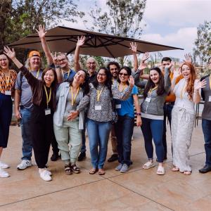 Group of volunteers outdoors waiving