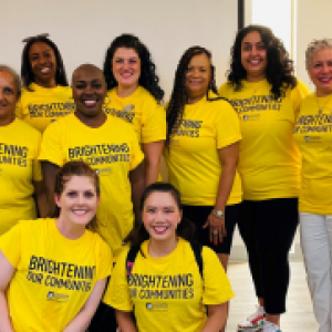 A group of people posed in matching shirts.