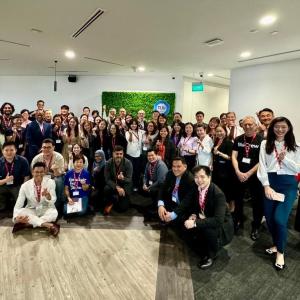 A group of people posed in an open room.