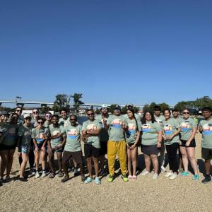 A group posed on a beach.