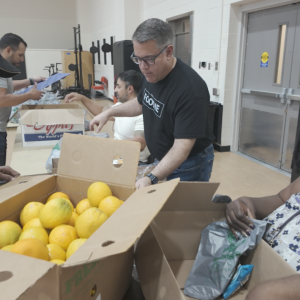 Volunteers unpacking boxes of food.