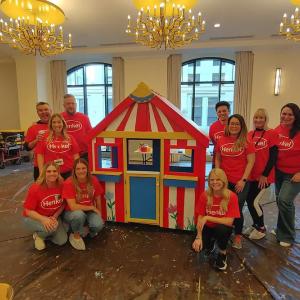 A group surrounding a finished playhouse.