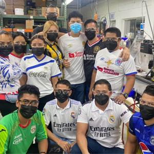 Employees each wearing team jerseys