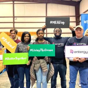 A group of people posed, each holding a sign.