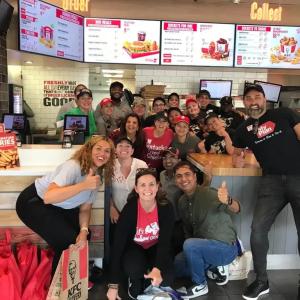 A team of people posed in a restaurant.