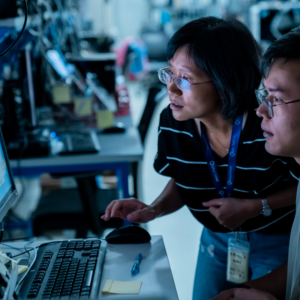 Two people looking at the same computer screen.