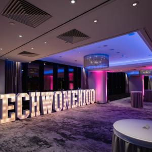 A large lighted sign reading TECHWOMEN100