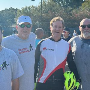 A team of four posed on a tennis court