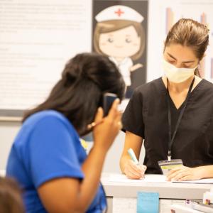 Two health care workers at reception desk