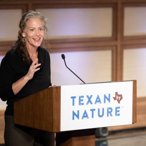 Joni Carswell speaking at a podium