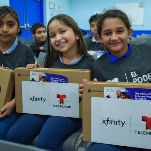 3 students with new laptops