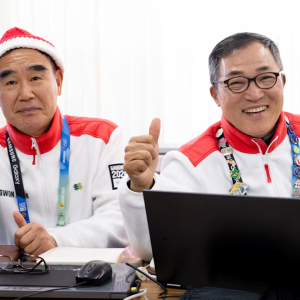 2 people give a thumbs up gesture