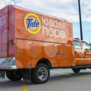 Orange truck and trailer, Tide Loads of Hope on the side