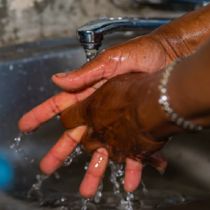 Handing being washed in sink