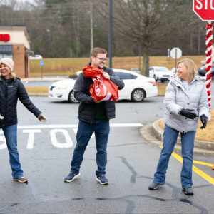 Volunteers handing presents off