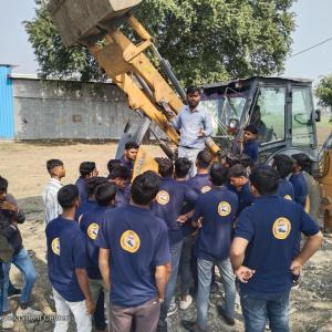 A group of students around farm machinery