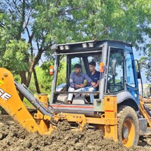 Someone being trained in operating farm machinery