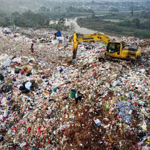 An excavator at a large landfill
