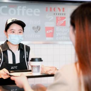 KFC employee with drink on a tray
