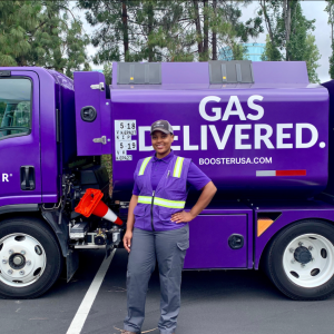 Booster Fuels driver standing in front of truck
