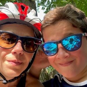 Two people taking a selfie, One has a bike helmet on.