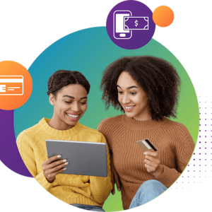 two people seated together, one holding a credit card and the other a tablet