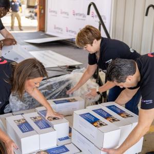 Volunteers un wrapping boxes.