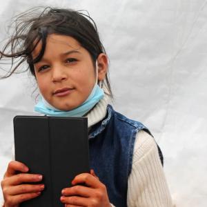 A child holding an electronic tablet