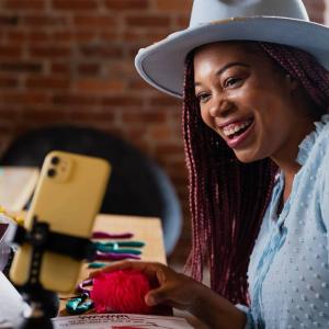 Person learning with a phone and laptop