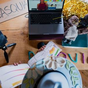 Top down view of person learning with a phone and laptop