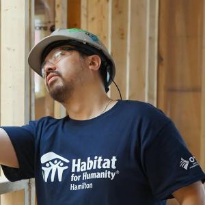 A volunteer inspecting wood framing.