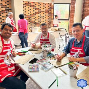 A group of volunteers at a table coloring bags.
