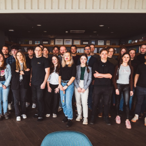 A large group of people standing in an open doorway.