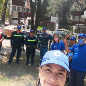 A group of people posed doing volunteer work.