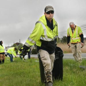 Volunteers working on the side of a road.