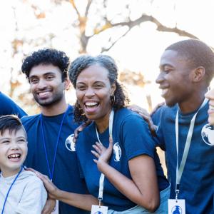 A group of people wearing matching shirts and lanyards