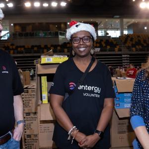 A group of posed volunteers in santa hats.