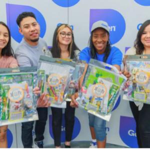 Volunteers holding out kits